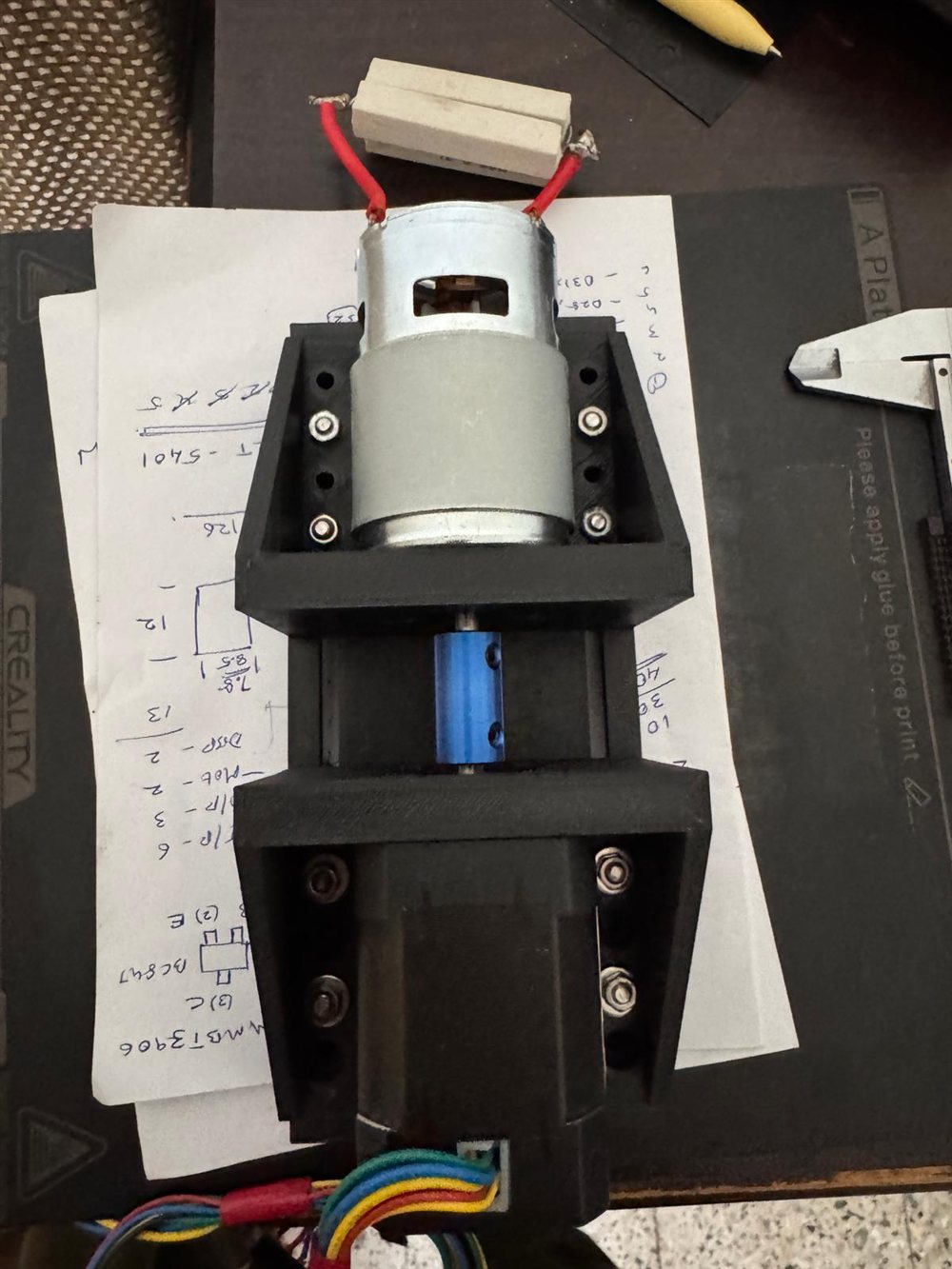 A 3D-printed test rig with a motor coupled to a second motor through a blue shaft coupler